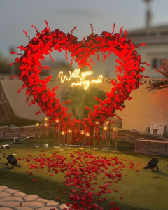 A heart made of roses with "Will You Marry Me"