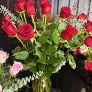 A stunning vase of long-stem red roses with eucalyptus and greenery—perfect for romance, celebrations, and meaningful moments.